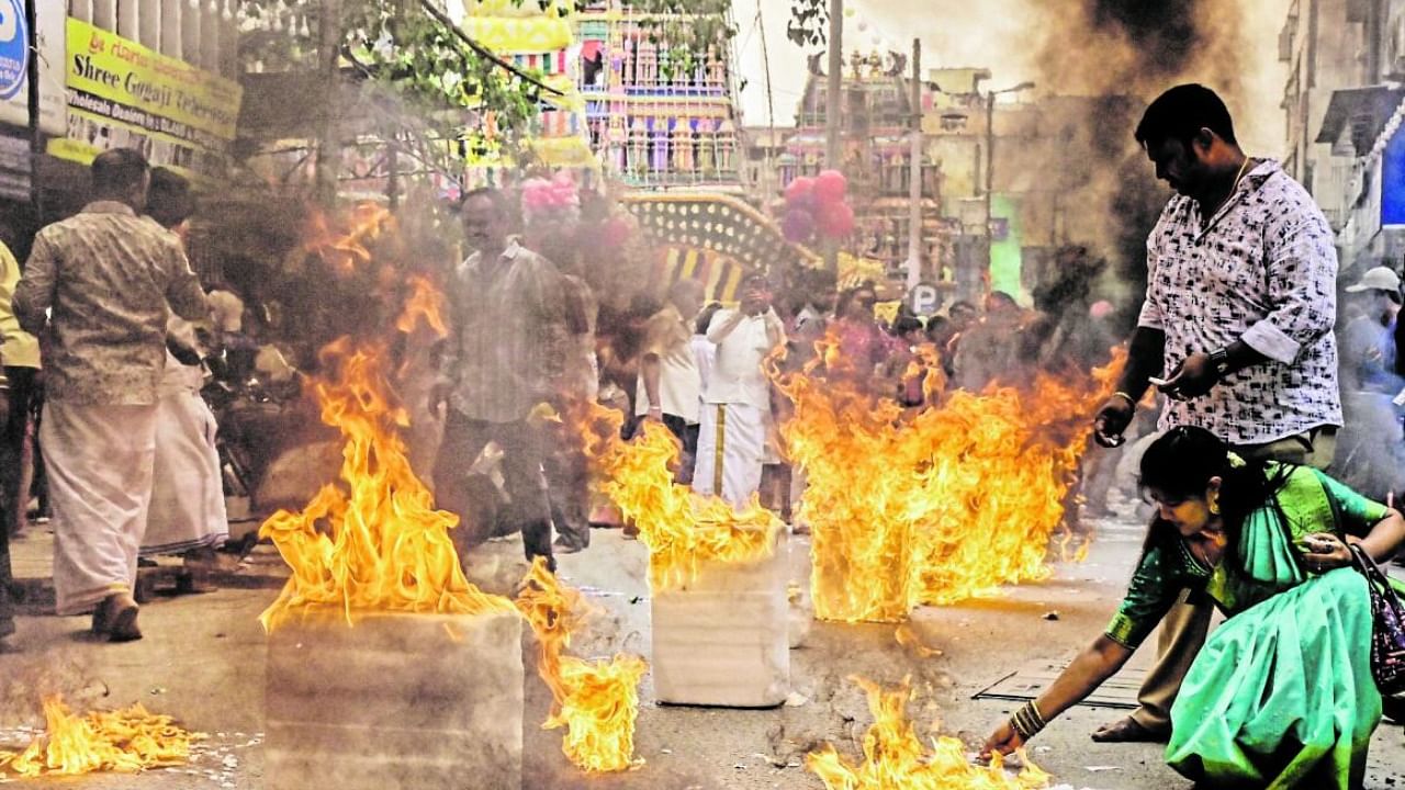 Organisers had lit camphor blocks on a stretch near the Shri Dharmaraya Swamy temple in Thigalarpet on Thursday. Credit: DH Photo/Prashanth H G