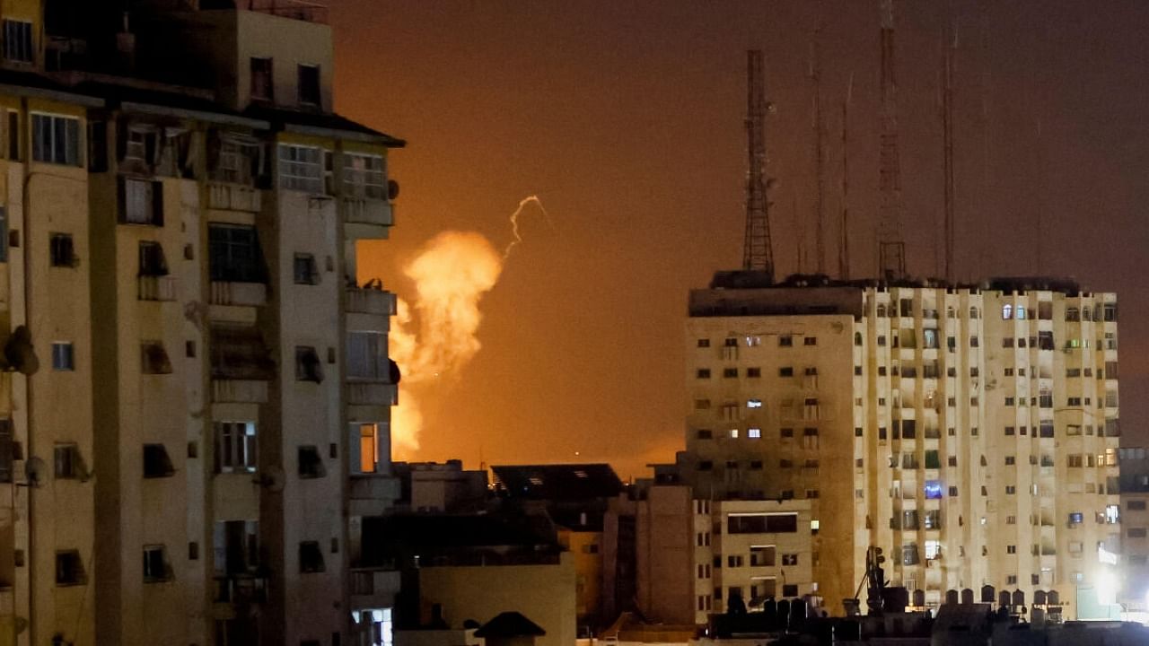 Smoke rises amid buildings during Israeli airstrikes in Gaza. credit: Reuters