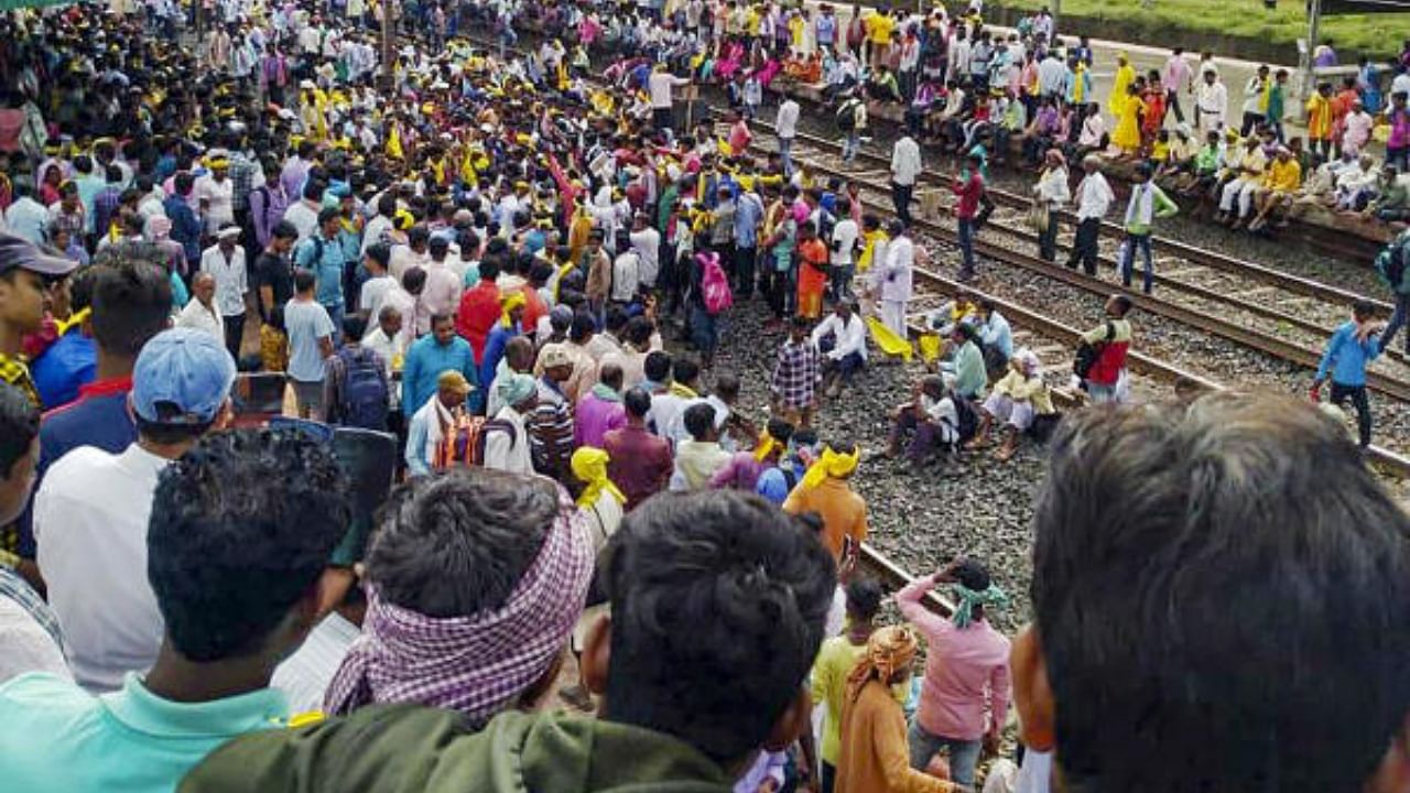 Agitators from the Kurmi community block railway tracks to press for their demand for Scheduled Tribe (ST) status. Credit: PTI Photo