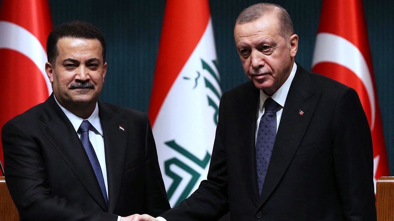 This handout photo taken and released by the Turkish Presidential Press Service shows Turkish President Recep Tayyip Erdogan (R) and Iraqi Prme Minister Mohamed Shia al-Sudani (L) shaking hands during a joint press conference after their meeting at the Presidential Palace in Ankara on March 21, 2023. Credit: AFP/Turkish Presidential Press Service