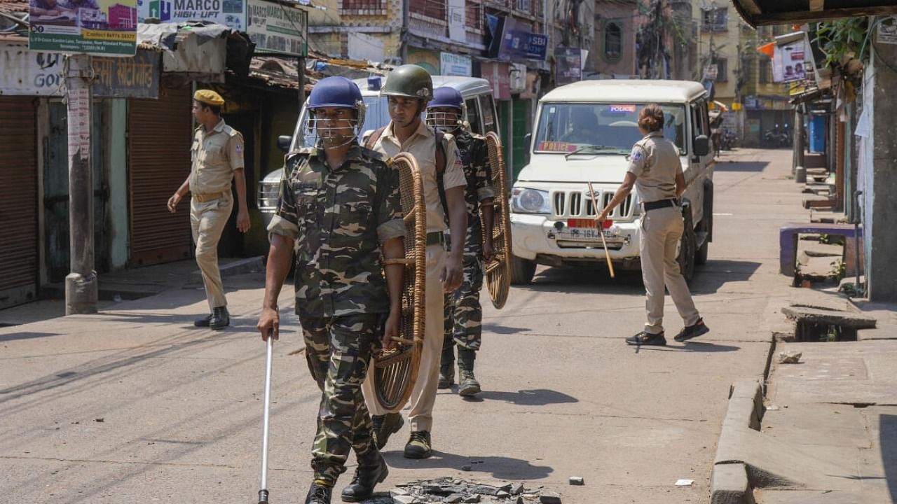 Security personnel march during the imposition of Section 144 in an area a day after clashes that broke out between two groups during a Ram Navami procession, in Hooghly. credit: PTI File Photo
