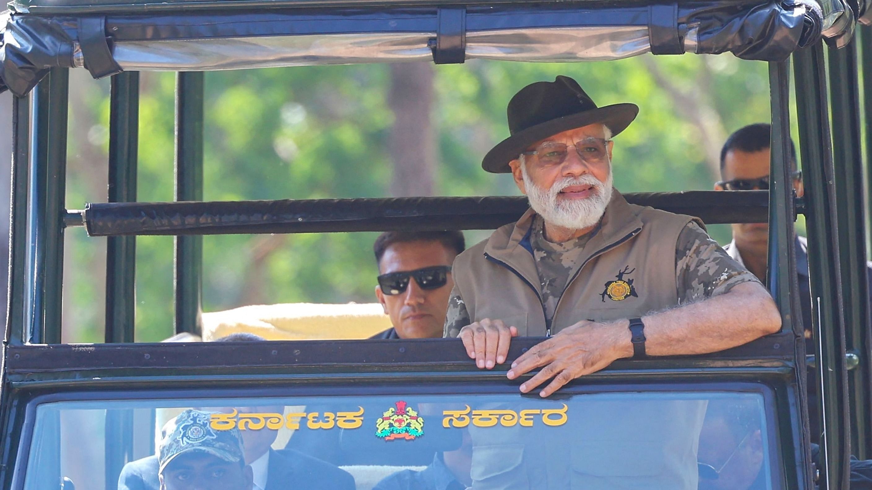 This handout photograph taken on April 9, 2023 and released by the Indian Press Information Bureau (PIB) shows India's Prime Minister Narendra Modi taking a jungle safari during his visit to the Bandipur and Mudumalai Tiger Reserves, in Karnataka state. - India's wild tiger population -- by far the largest in the world -- has risen above 3,000, according to a census released on April 9. Credit: AFP Photo