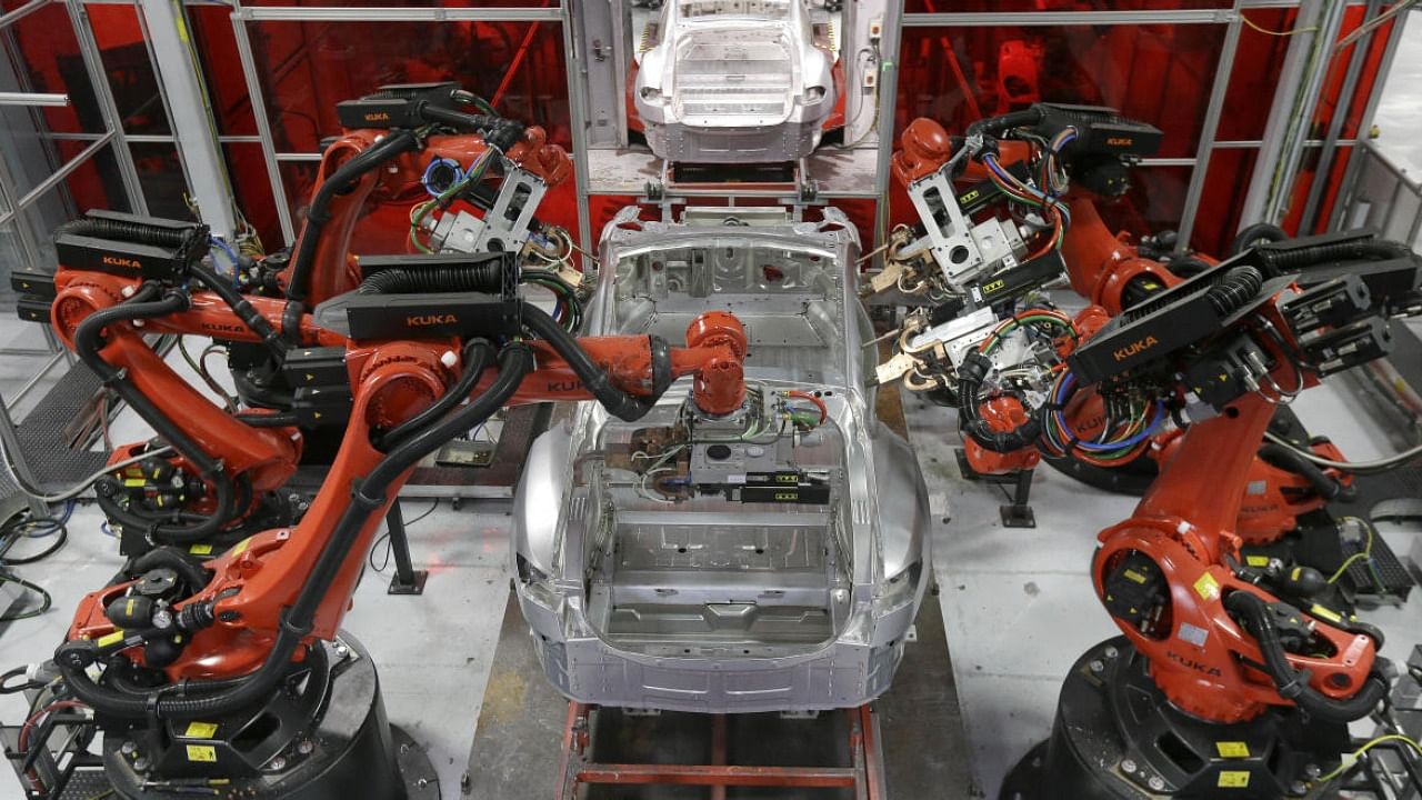 Kuka robots work on Tesla Model S cars in a factory in Fremont, California. credit: AP File Photo