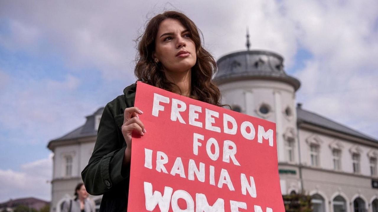 A woman takes part in a rally in support of Iranian women in Pristina. Credit: AFP File Photo