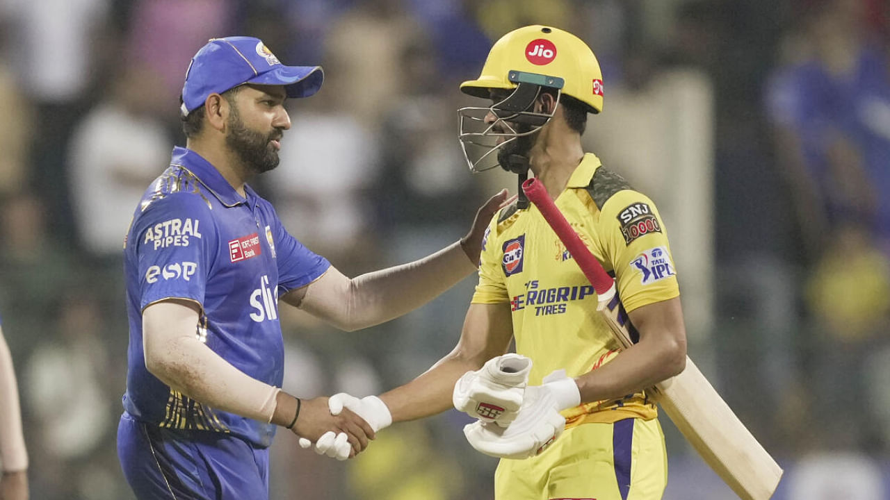 MI captain Rohit Sharma shakes hands with Chennai's Raju Gaikwad after the match between the two sides. Credit: PTI Photo