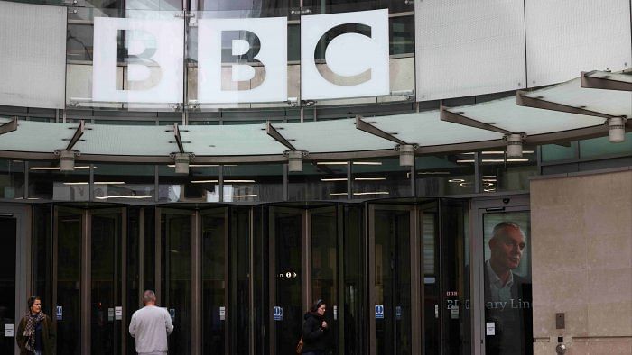 An image of British Broadcasting Corporation (BBC) Director-General Tim Davie is seen through the door at the BBC headquarters in London. Credit: Reuters Photo  