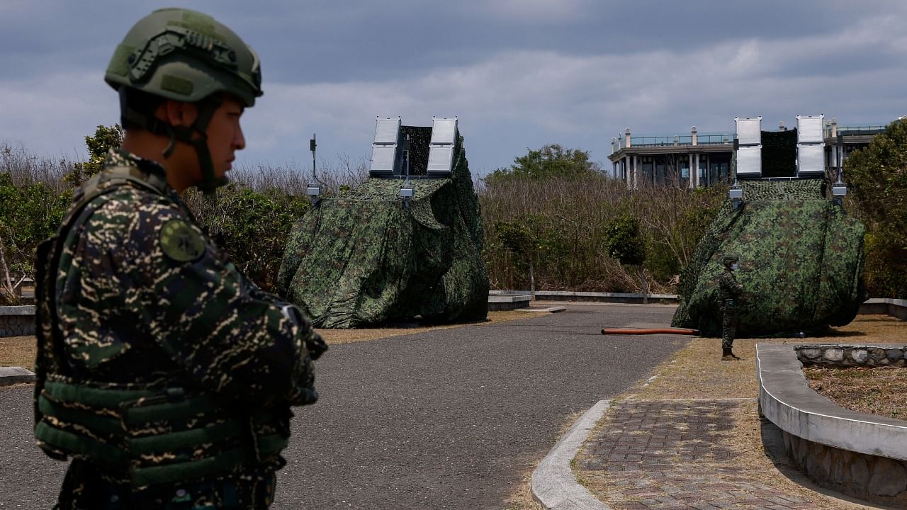 A soldier stands near Hsiung Feng mobile missile launchers at Cape Maobitou park in Pingtung County. Credit: Reuters Photo