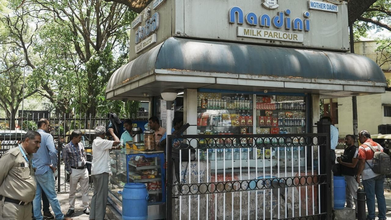  Customers at a Nandini milk shop, amid reports claiming the entry of Amul products in Karnataka market, in Bengaluru. Credit: PTI Photo