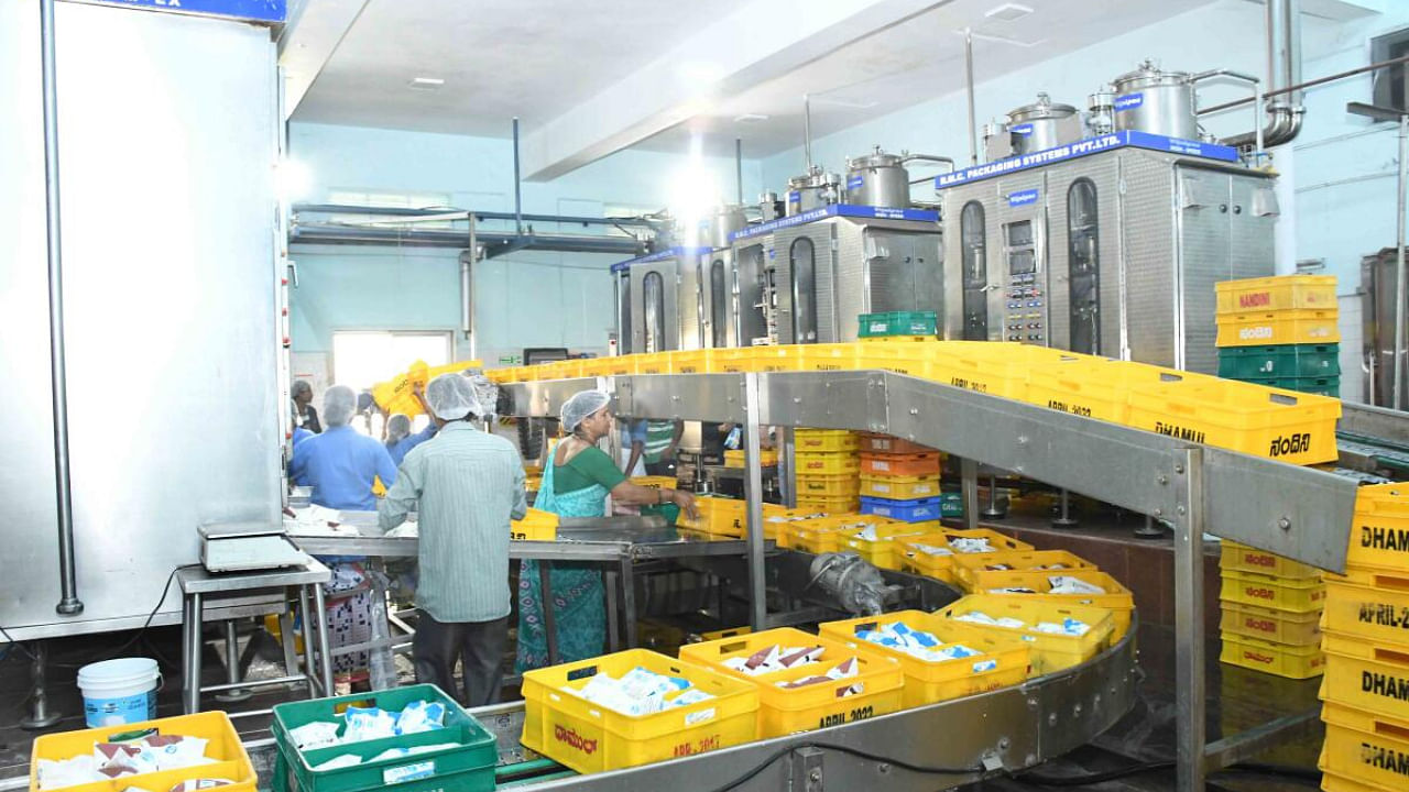 Staff pack milk packets at Dharwad KMF. Credit: DH Photo