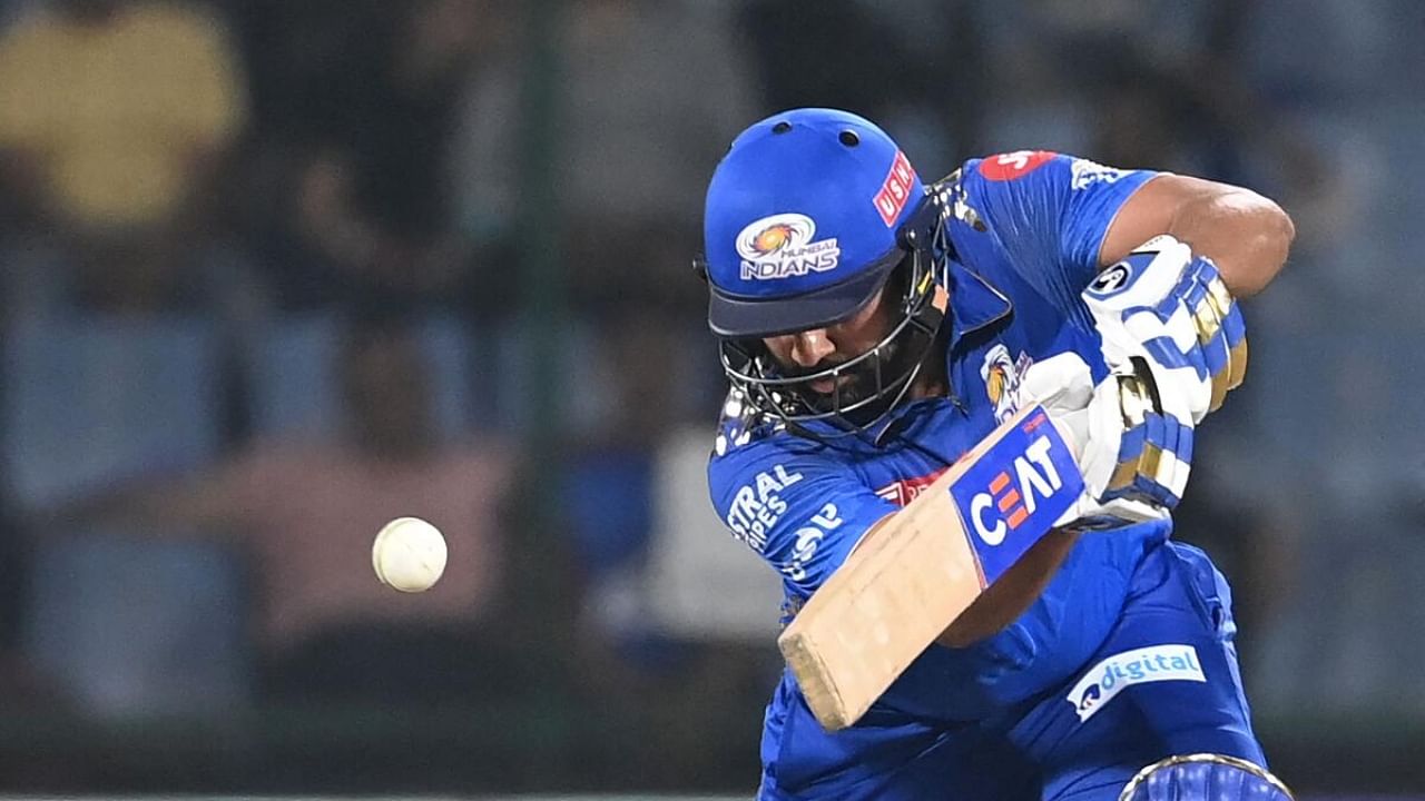 Mumbai Indians' Rohit Sharma watches the ball after playing a shot during the Indian Premier League (IPL) Twenty20 cricket match between Delhi Capitals and Mumbai Indians at the Arun Jaitley Stadium in New Delhi on April 11, 2023. Credit: AFP Photo