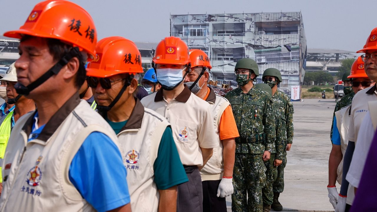 Civilians and soldiers stand during the annual Minan civilian defense drill, which this years focuses on the response from various agencies and volunteer groups if under attack by China, in Taichung, Taiwan. Credit: Reuters Photo