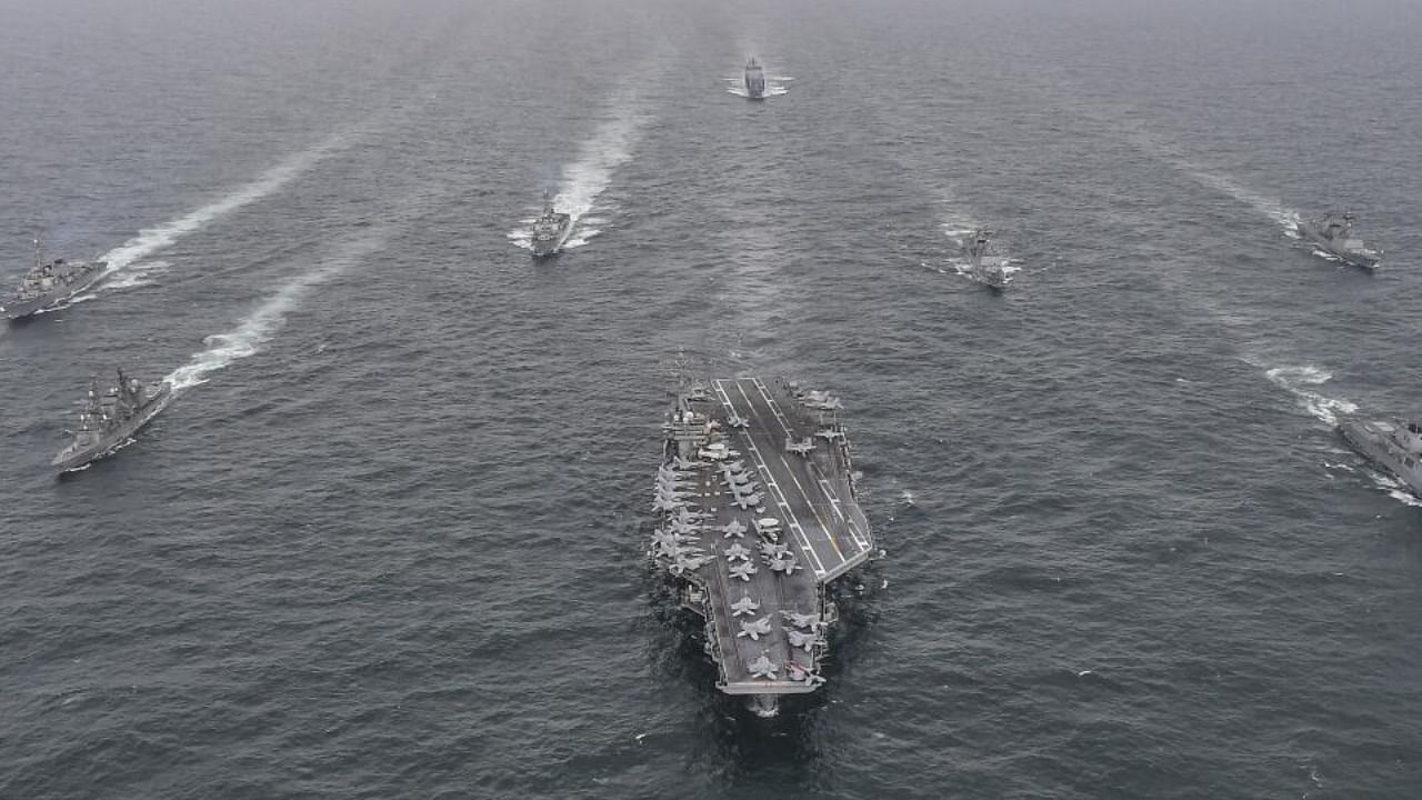 South Korean Navy's destroyer Yulgok Yi I, front row right, US Navy's aircraft carrier USS Nimitz, center, Japan Maritime Self-Defense Force's Umigiri, front row left, sail in formation during a joint naval exercise. credit: AP File Photo
