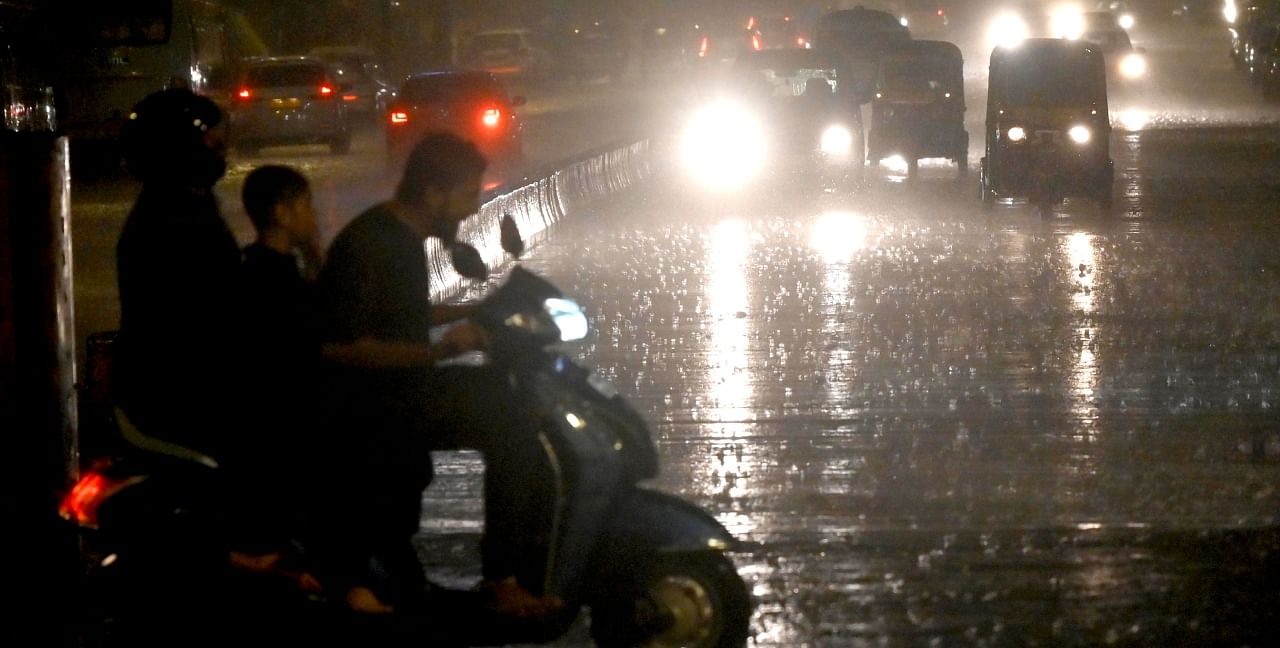 Vehicles ply on the Western Express Highway amid rains at Andheri in Mumbai. Credit: PTI Photo