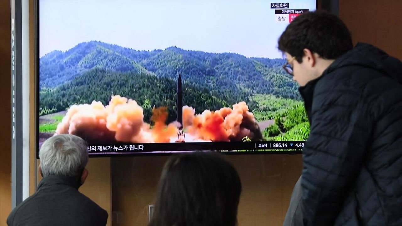 People watch a television screen showing a news broadcast with file footage of a North Korean missile test, at a railway station in Seoul on April 13, 2023. Credit: AFP Photo