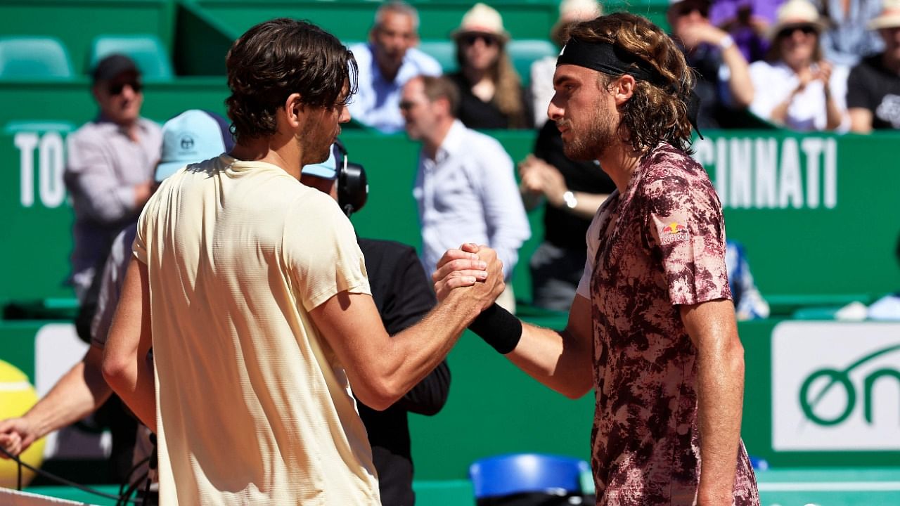 USA's Taylor Fritz (L) shakes hands with Greece's Stefanos Tsitsipas after winning. Credit: AFP Photo