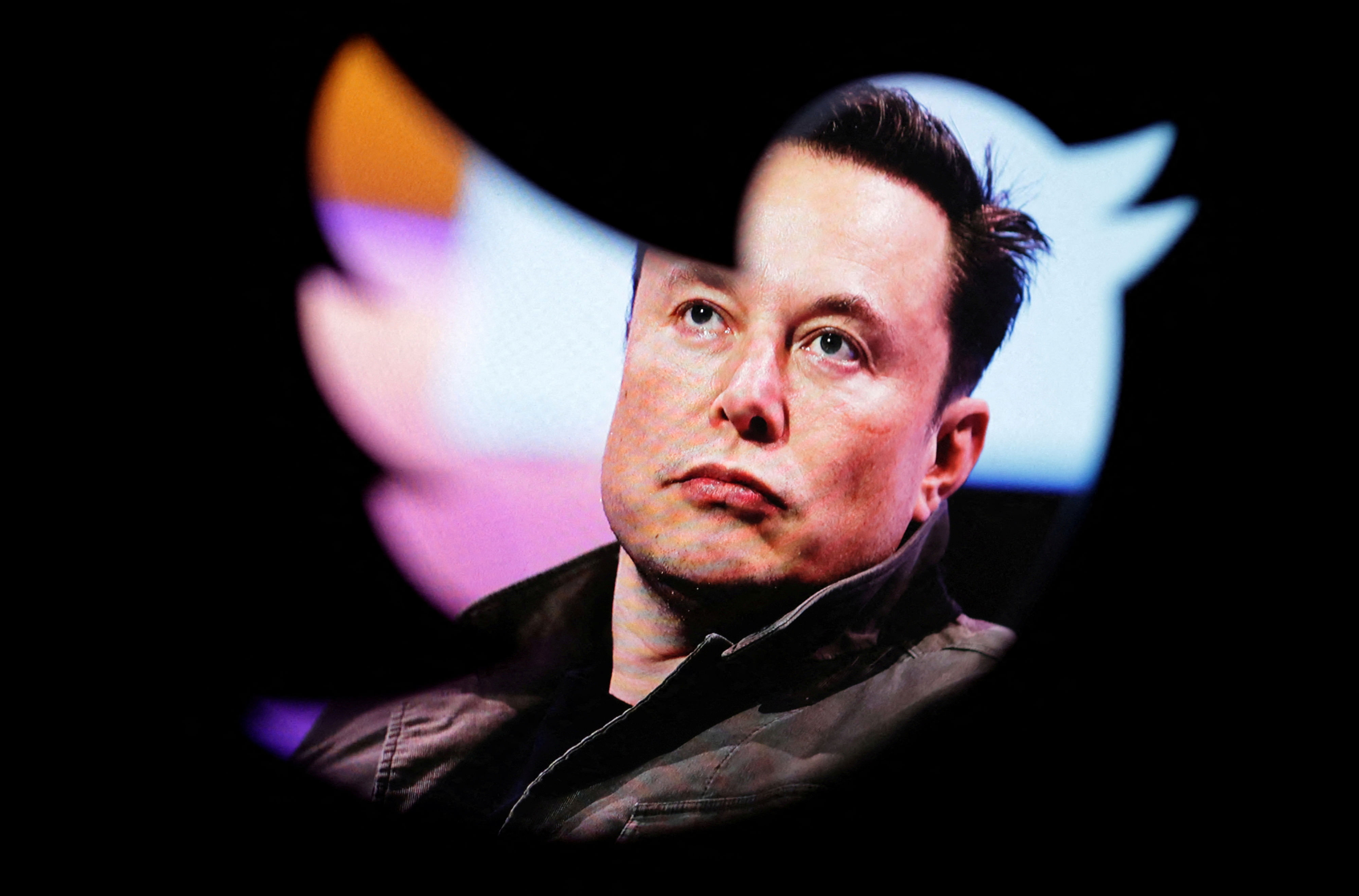 Elon Musk's photo is seen through a Twitter logo in this illustration. Credit: Reuters File Photo