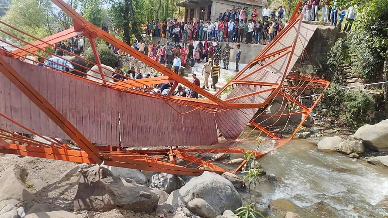  People gather after a footbridge collapsed during the Baisakhi celebration at Beni Sangam, in Udhampur. credit: PTI Photo