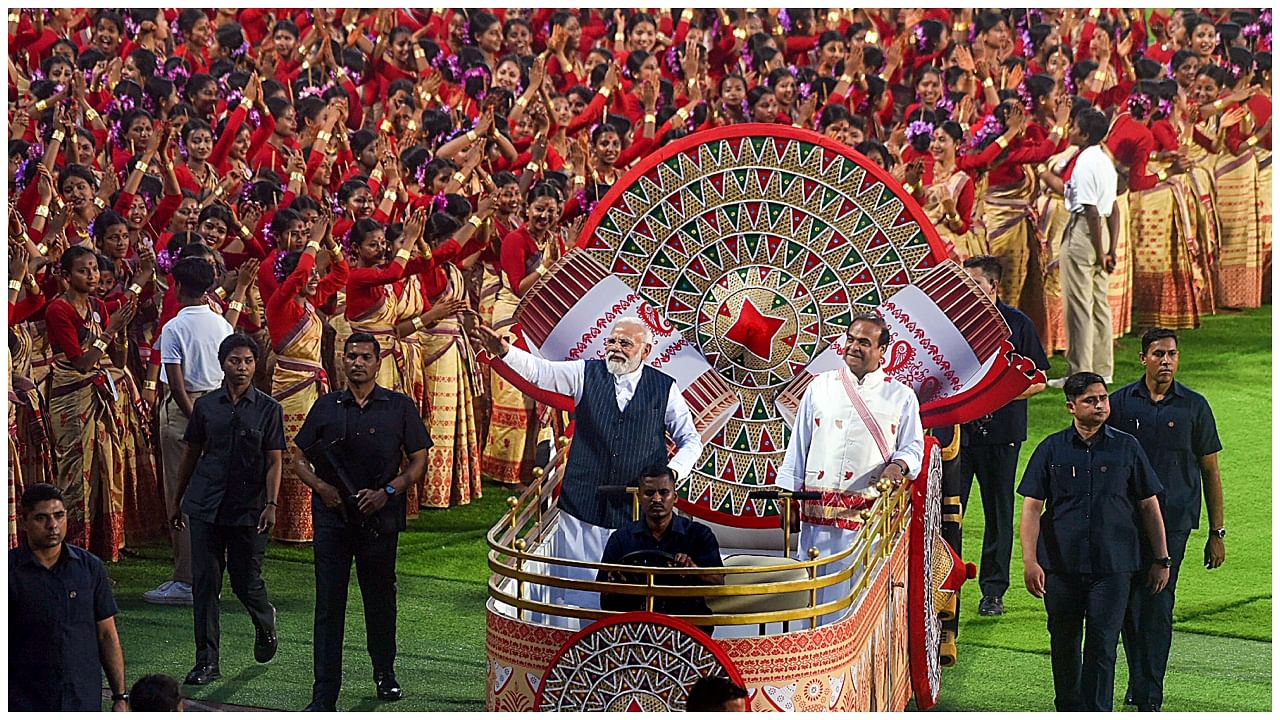 Prime Minister Narendra Modi with the Assam CM Himanta Bishwa Sharma during the mega Bihu dance program at Sarusajai Sports Complex, in Guwahati, Friday, April 13, 2023. Credit: PTI Photo