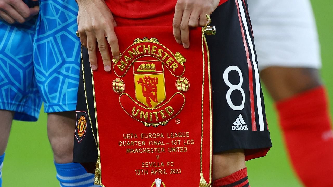 Manchester United's Bruno Fernandes holds a pennant before the match vs Sevilla. Credit: Reuters Photo