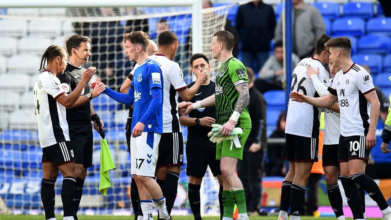 Players and officials shake hands after the match. Credit: Reuters Photo