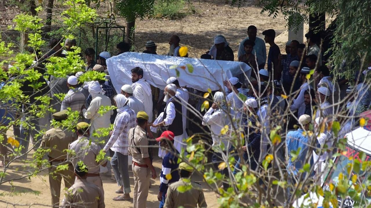 The mortal remains of gangster-turned-politician Atiq Ahmed's son Asad Ahmed being brought for the last rites, who was killed in an encounter in Jhansi, at the Kasari-Masari graveyard in Prayagraj. Credit: PTI Photo