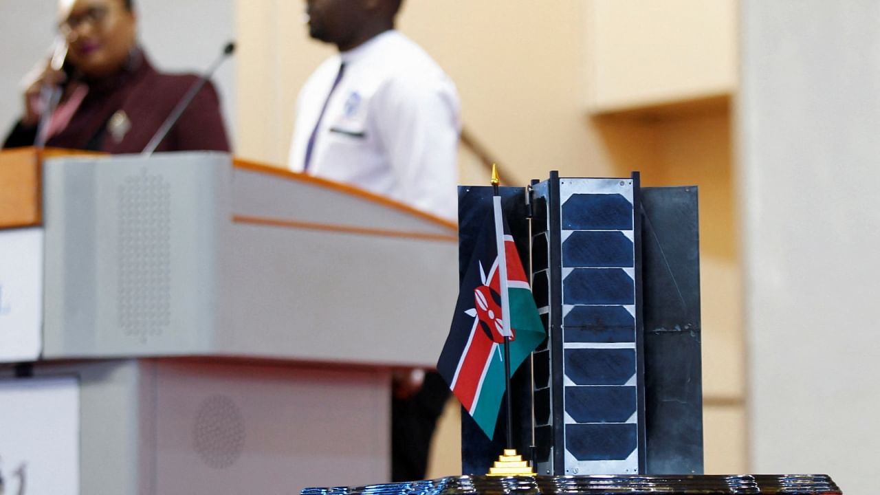 A model of a prototype of a 3U Earth observation satellite, the Taifa-1, is displayed as delegates attend the preparation of the launch of Kenya's first operational satellite, at the University of Nairobi's Taifa Hall in Nairobi, Kenya. Credit: Reuters Photo