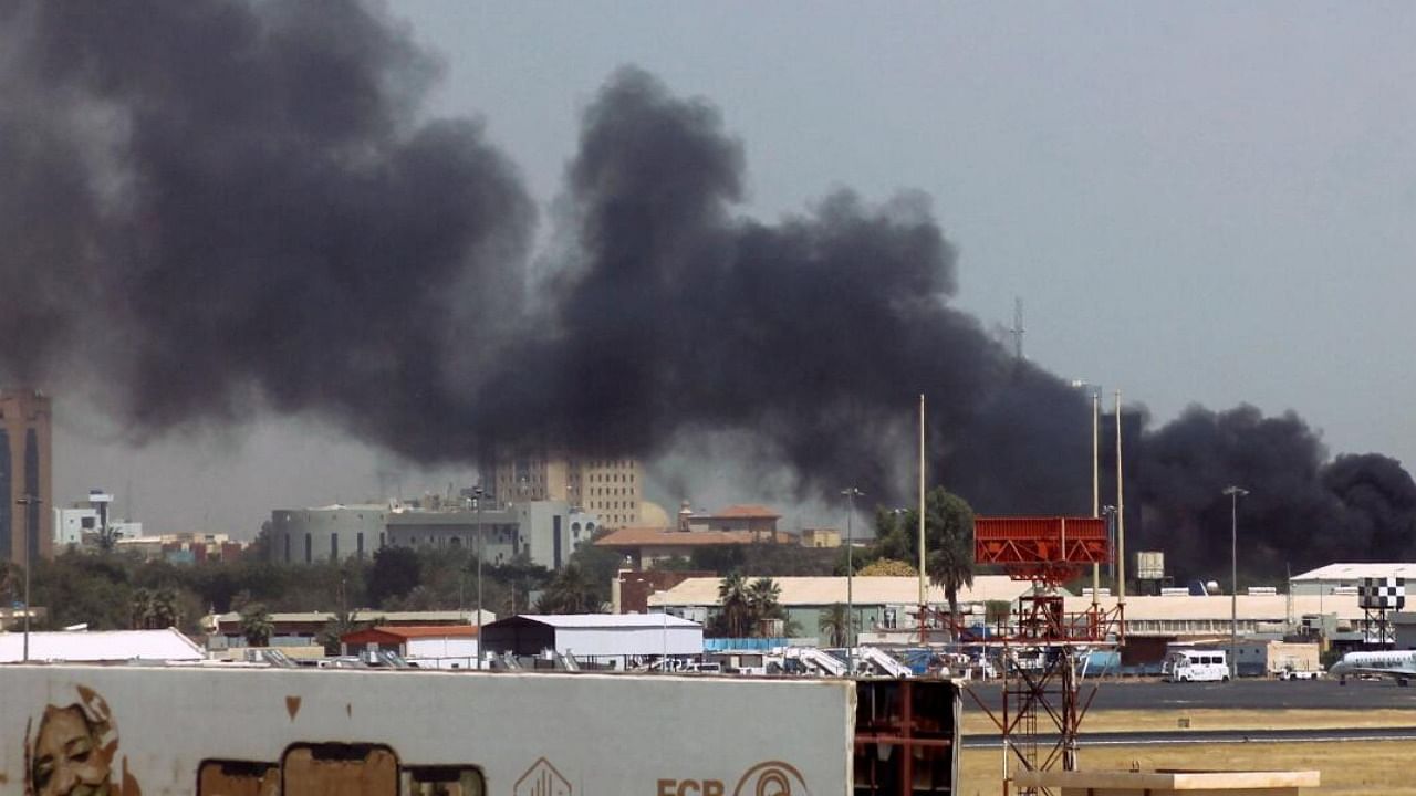 Heavy smoke bellows above buildings in the vicinity of the Khartoum airport. credit:  AFP Photo