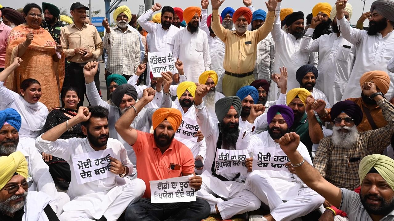 Activists of India's Aam Aadmi Party (AAP) shout slogans during a demonstration after Delhi's chief minister Arvind Kejriwal was allegedly summoned by the Central Bureau of Investigation (CBI), in Amritsar on April 16, 2023. Credit: AFP Photo