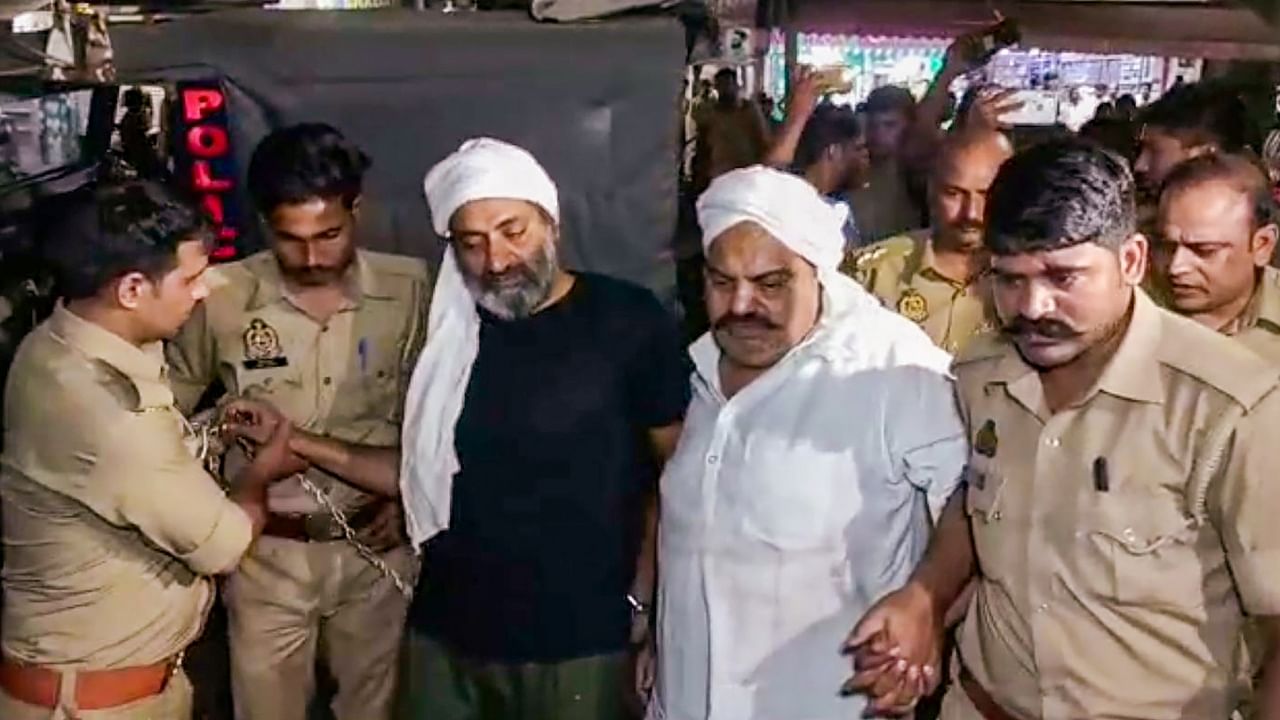 Gangster-turned-politician Atiq Ahmed and his brother Ashraf Ahmed being escorted to a hospital by police for a medical checkup, in Prayagraj, April 15, 2023. Atiq and Ashraf were shot dead by three assailants while being taken for the medical. Credit: PTI Photo