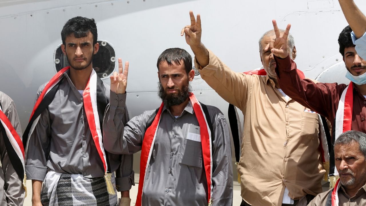 Freed prisoners gesture after arriving at Marib Airport on an International Committee of the Red Cross (ICRC)-chartered plane, amid a prisoner swap between two sides in the Yemen conflict, in Marib, Yemen April 16. Credit: Reuters Photo