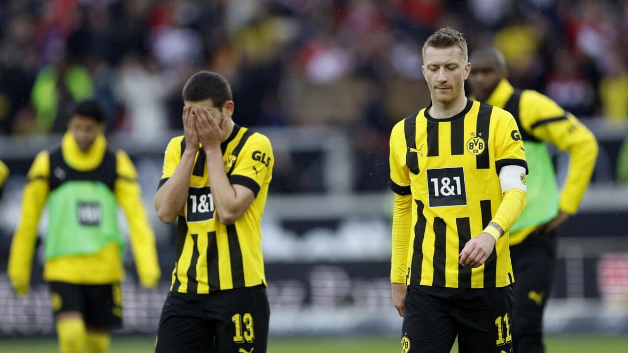 Borussia Dortmund conceded three late goals against 10-man Stuttgart and squandered the chance to capitalize on league leader Bayern Munich's 1-1 draw with Hoffenheim. Credit: Reuters Photo