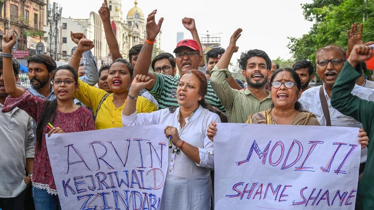  Aam Aadmi Party (AAP) workers raise slogans during a protest against the questioning of party Chief Arvind Kejriwal by CBI in Delhi's liquor policy case. Credit: PTI Photo