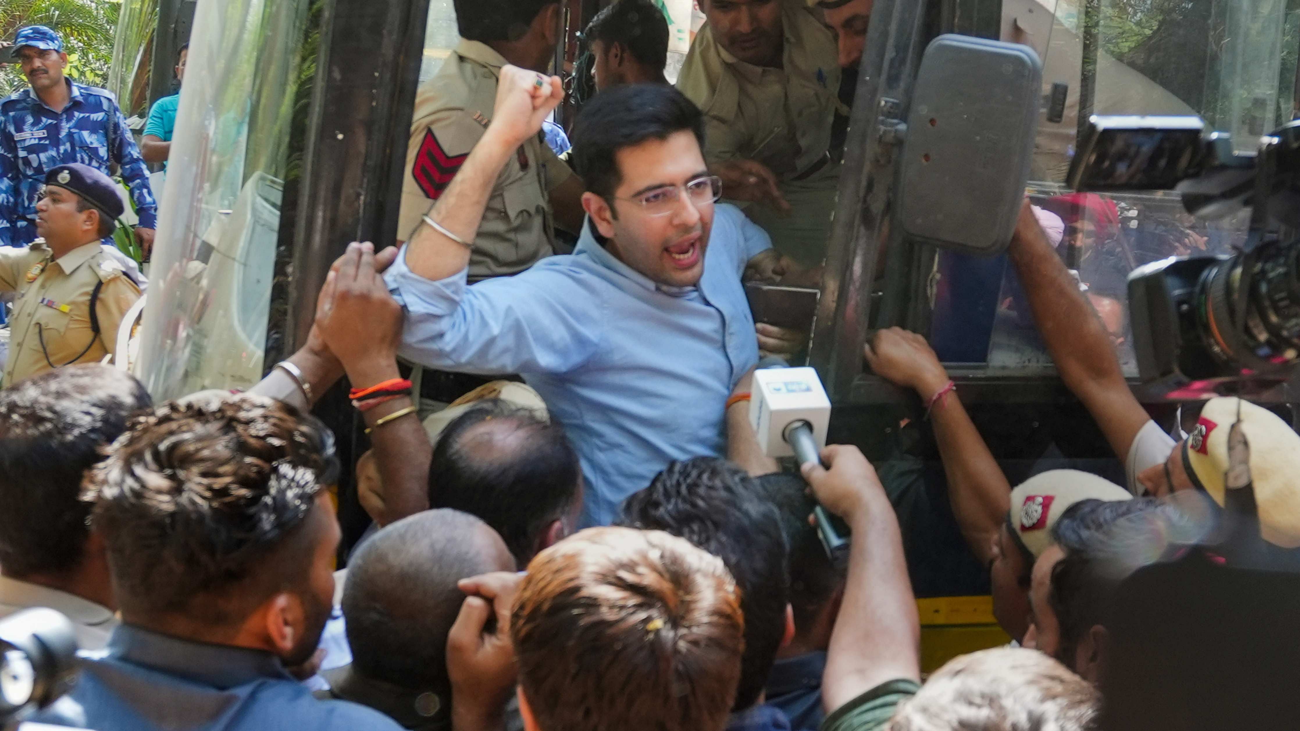 AAP MP Raghav Chadha being detained by police personnel during a protest. Credit: PTI Photo