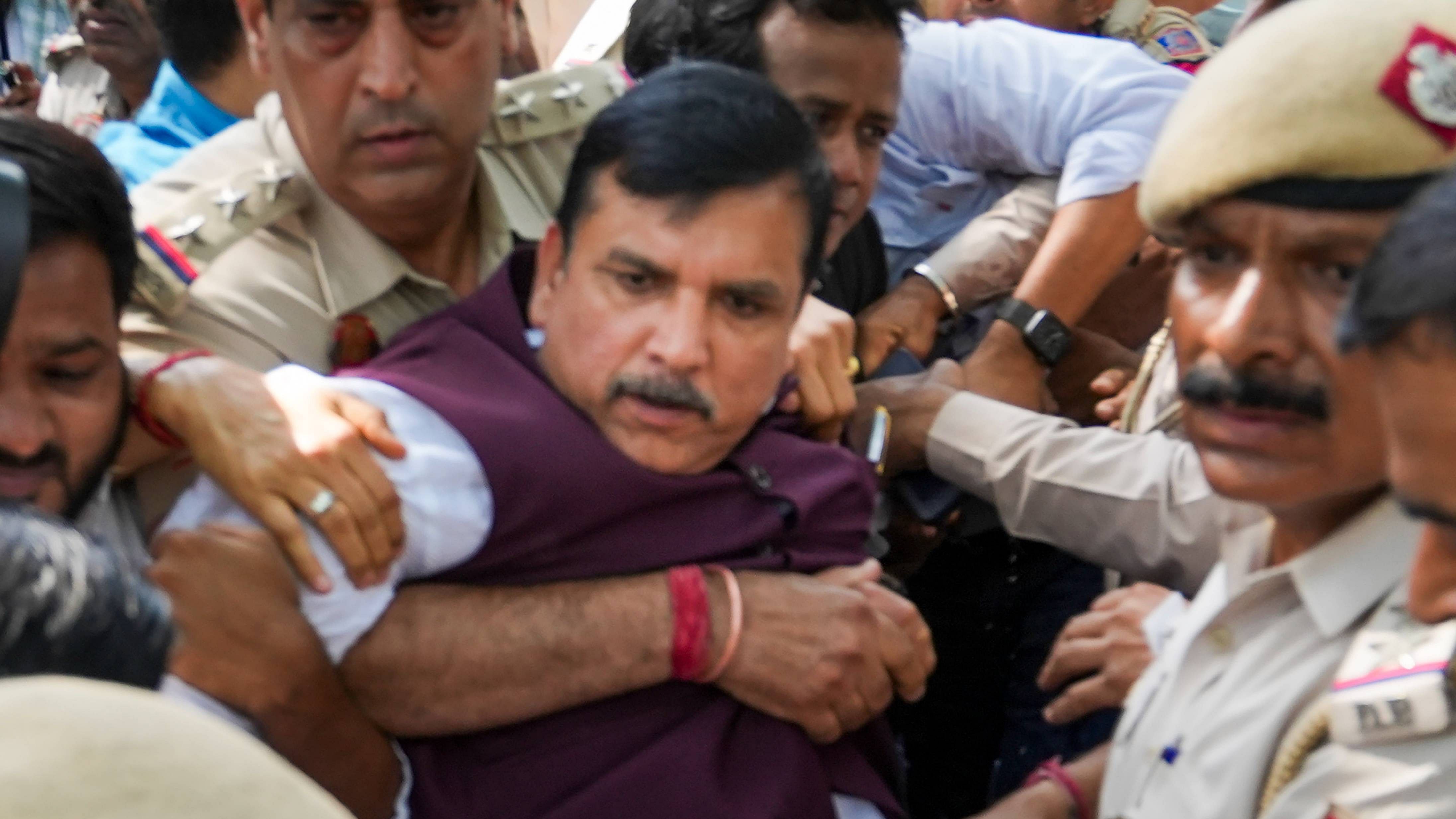 AAP MP Sanjay Singh being detained by police personnel during a protest against the questioning of Delhi Chief Minister Arvind Kejriwal by CBI. Credit: PTI Photo