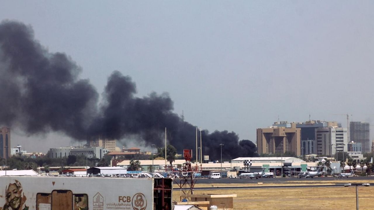 Heavy smoke bellows above buildings in the vicinity of the Khartoum's airport on April 15, 2023, amid clashes in the Sudanese capital. Credit: AFP Photo