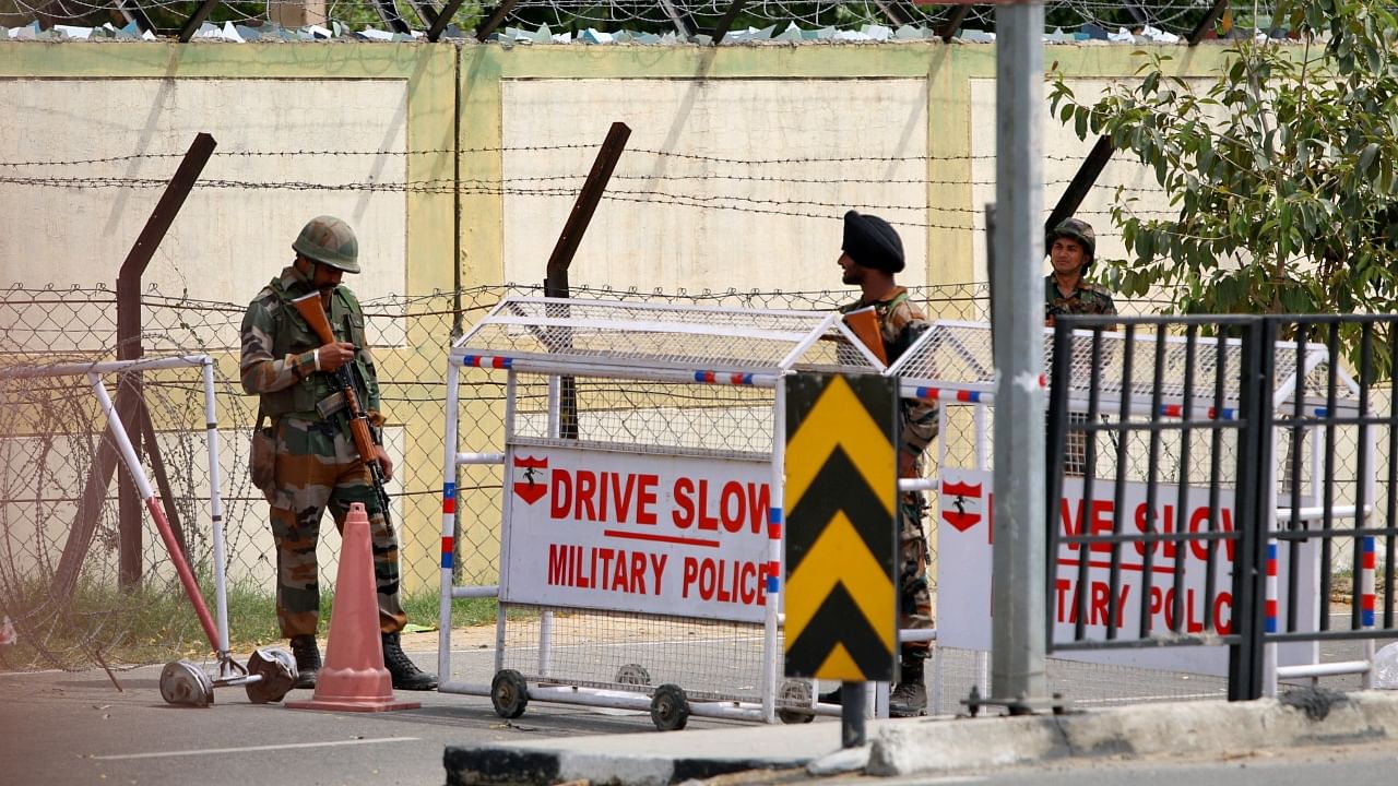 Indian army soldiers stand next to a barricade outside a military base, after a firing incident in Bathinda. Credit: Reuters Photo