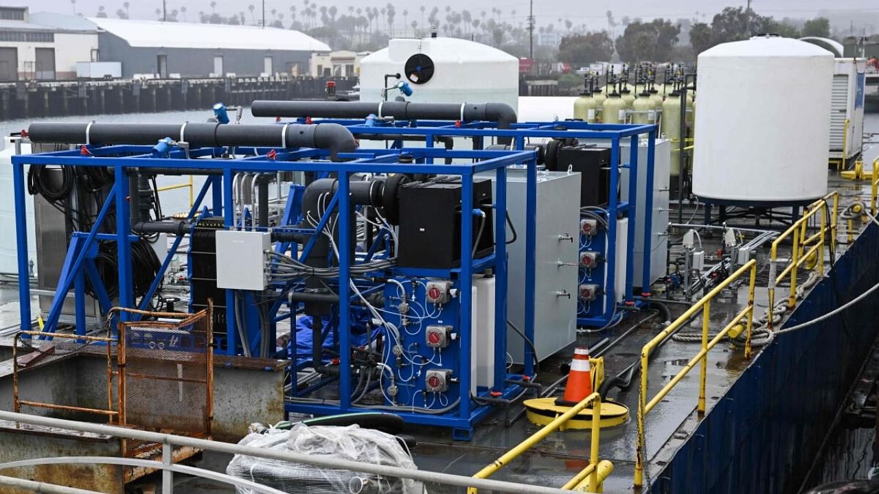 Equipment including an electrochemical reactor where seawater is split via electrolysis to capture carbon on a barge for UCLA’s SeaChange climate change carbon removal project at the Port of Los Angeles in San Pedro, California. Credit: AFP Photo