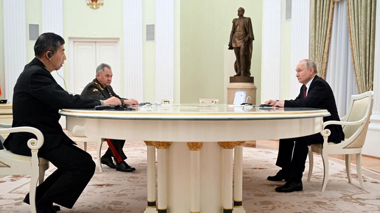 Russian President Vladimir Putin, Defence Minister Sergei Shoigu and Chinese Defence Minister Li Shangfu attend a meeting in Moscow. Credit: Reuters Photo