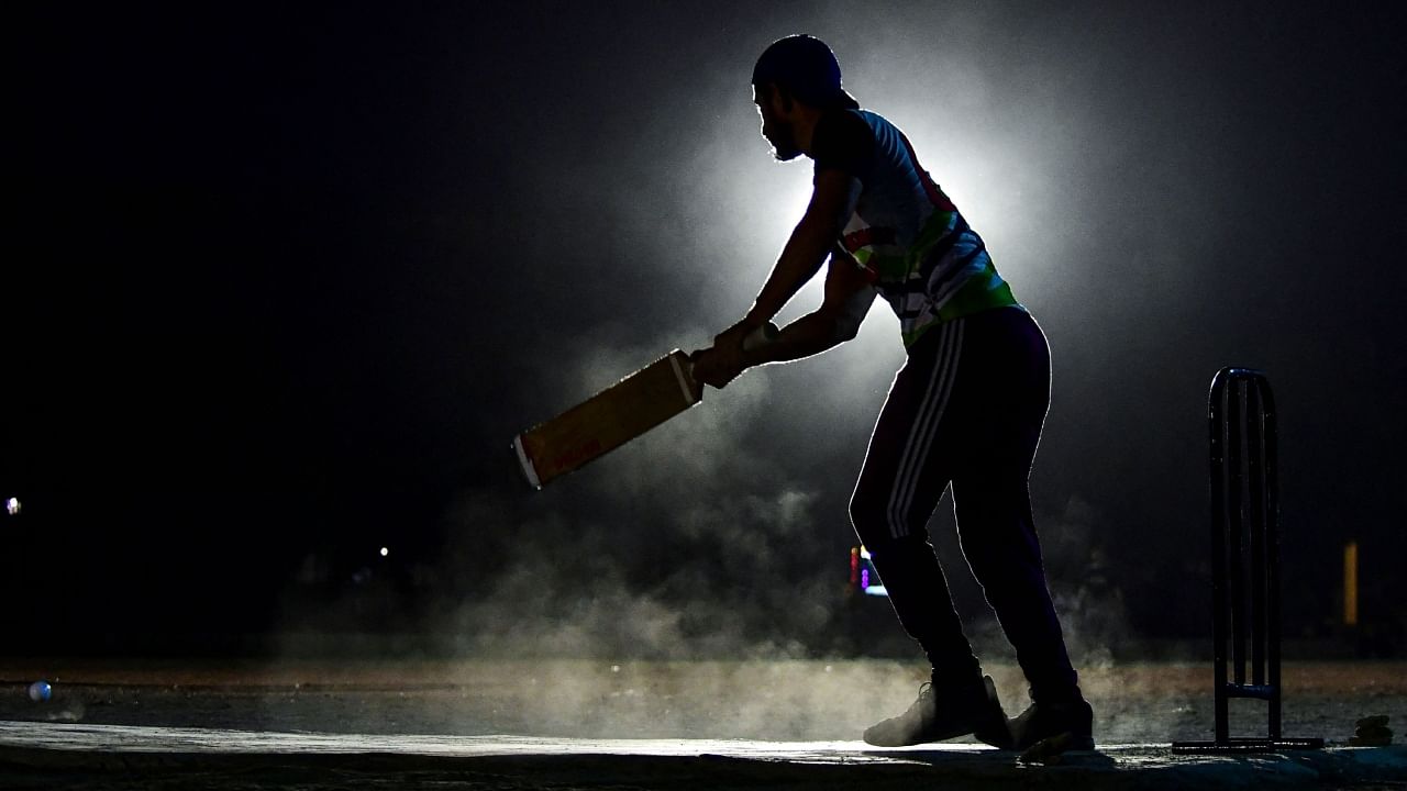 Cricketer Arbaz Khan plays a shot during the tape ball night cricket tournament during the Muslim holy fasting month of Ramadan in Karachi. Credit: AFP Photo
