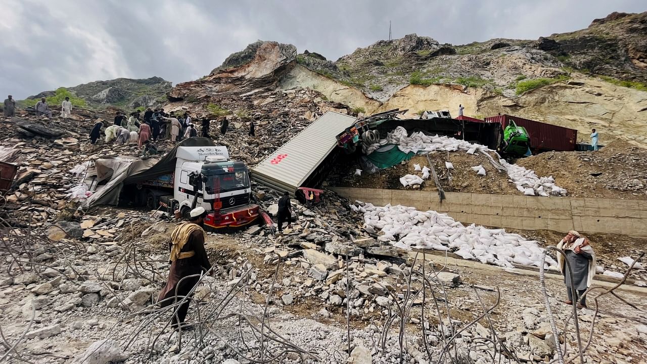 A view of trucks loaded with supplies are seen trapped in a landslide on the road close to the Torkham border, Pakistan April 18, 2023. Credit: Reuters Photo