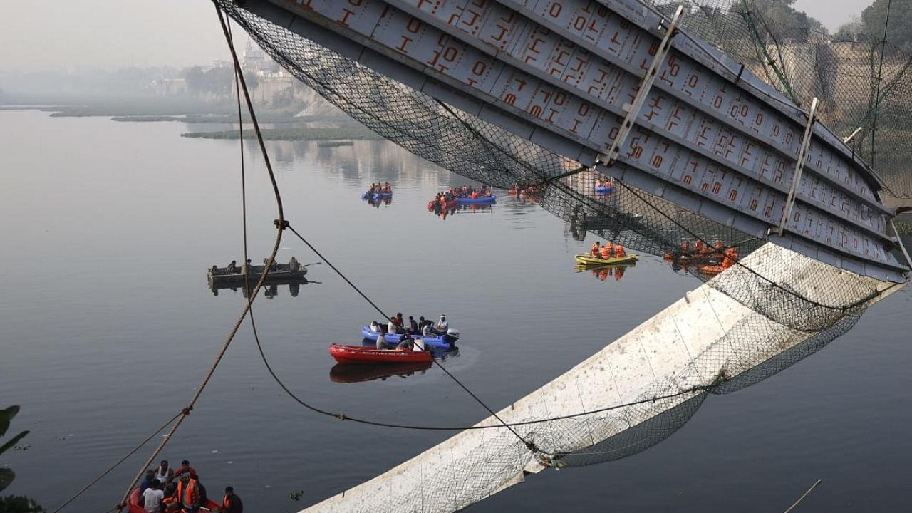 Rescue operation underway after the collapse of a suspension bridge over the Machchhu river, in Morbi. credit: PTI File Photo