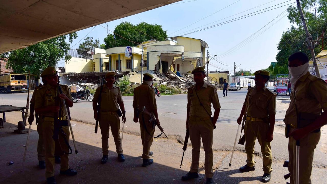Police personnel deployed outside the Kasari Masari office of gangster-turned-politician Atiq Ahmed as a security measure after the imposition of Section 144, following the gangster's death along with his brother Khalid Azim. Credit: PTI Photo
