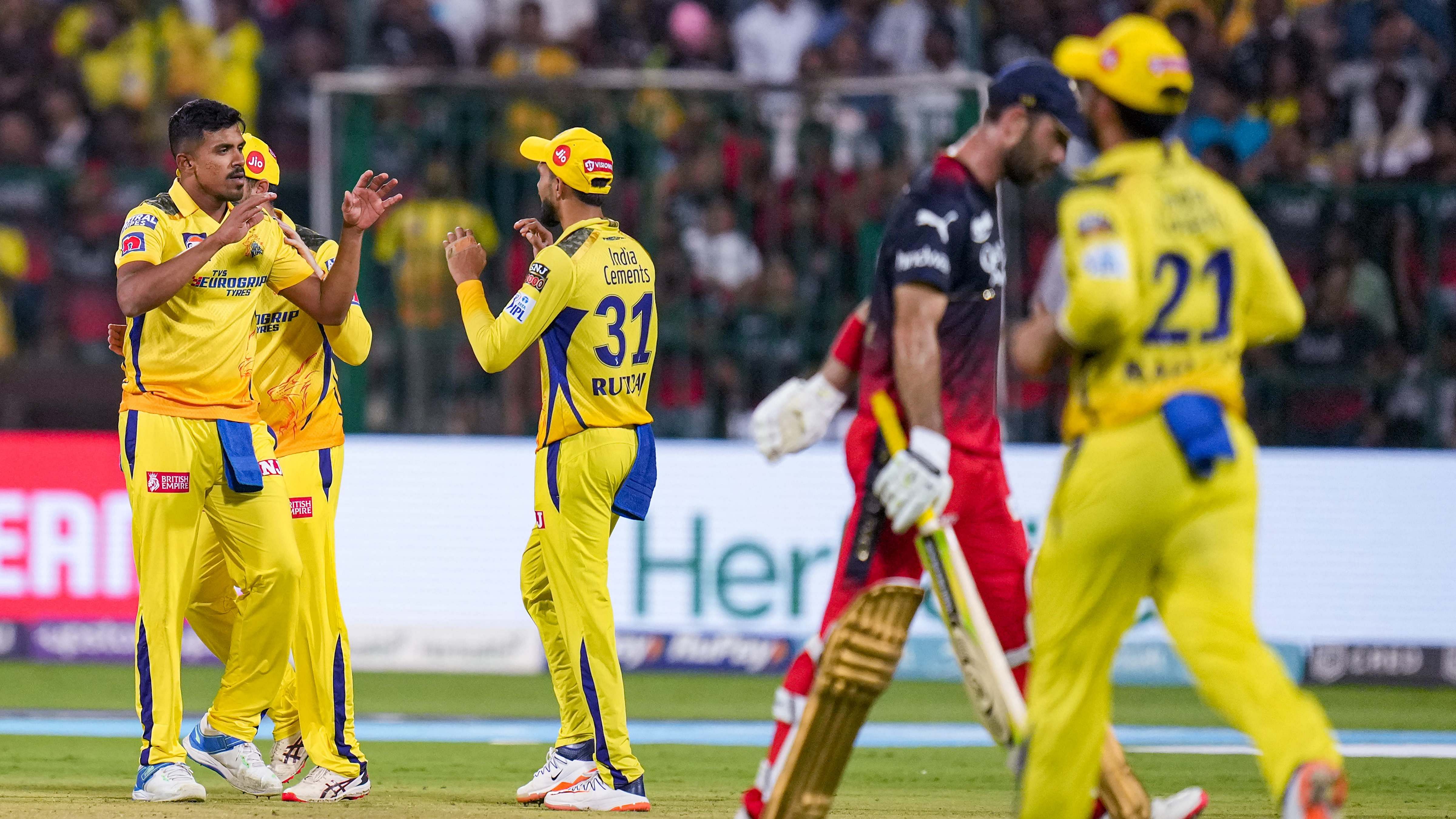 Chennai Super Kings bowler Maheesh Theekshana celebrates with teammates after taking the wicket of Royal Challengers Bangalore batter Glenn Maxwell. Credit: PTI Photo