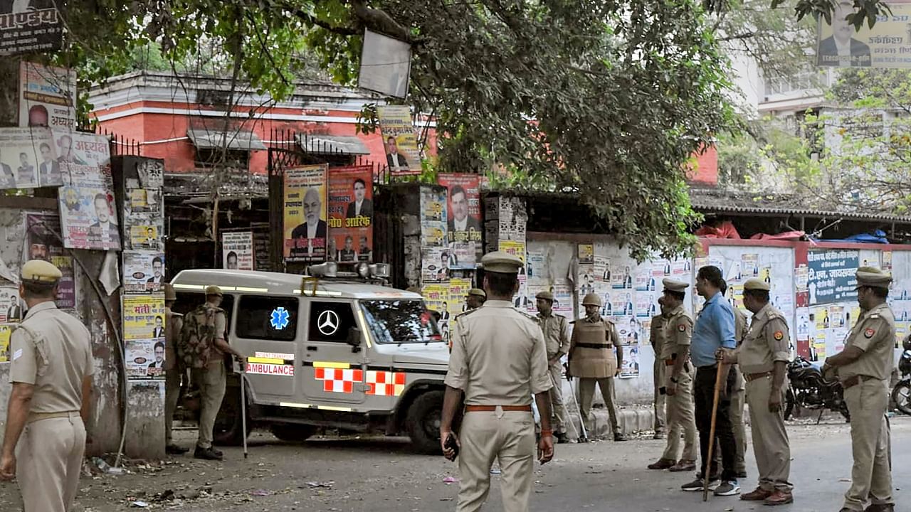 Police personnel stand guard as the three assailants who shot dead gangster-turned-politician Atiq Ahmed and his brother Ashraf are taken away in a vehicle after they were produced in a court, in Prayagraj, Sunday, April 16, 2023. Credit: PTI Photo