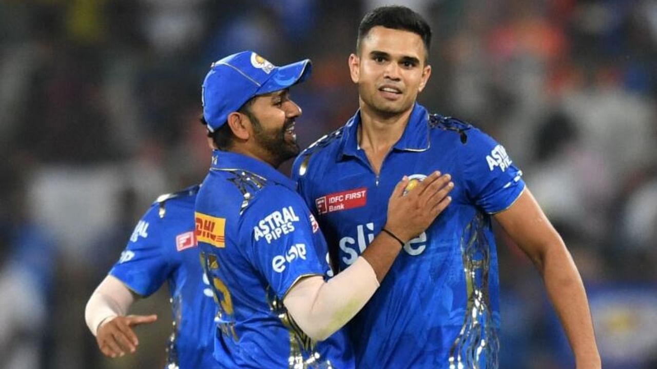 Mumbai Indians' Arjun Tendulkar (R) celebrates with his captain Rohit Sharma. Credit: AFP Photo