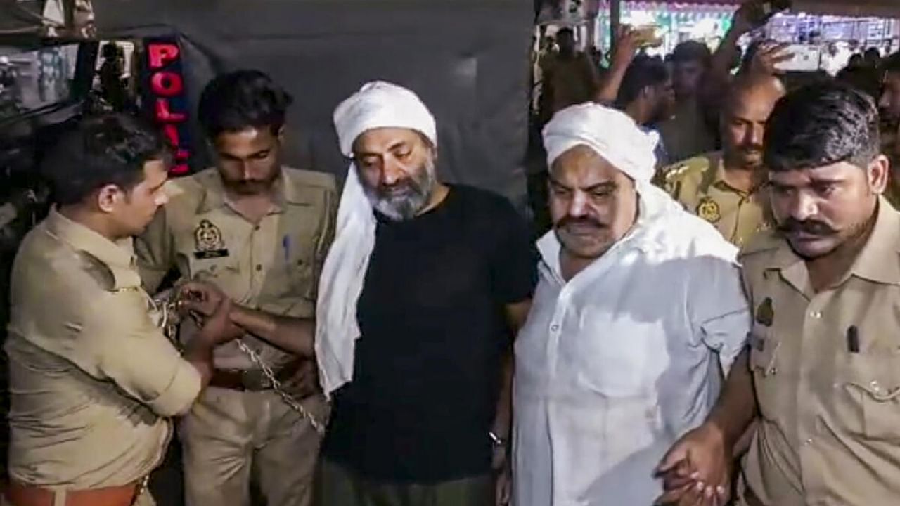 Gangster-turned-politician Atiq Ahmed and his brother Ashraf Ahmed being escorted to a hospital by police for a medical checkup, in Prayagraj, Saturday, April 15, 2023 before they were gunned down. Credit: PTI Photo