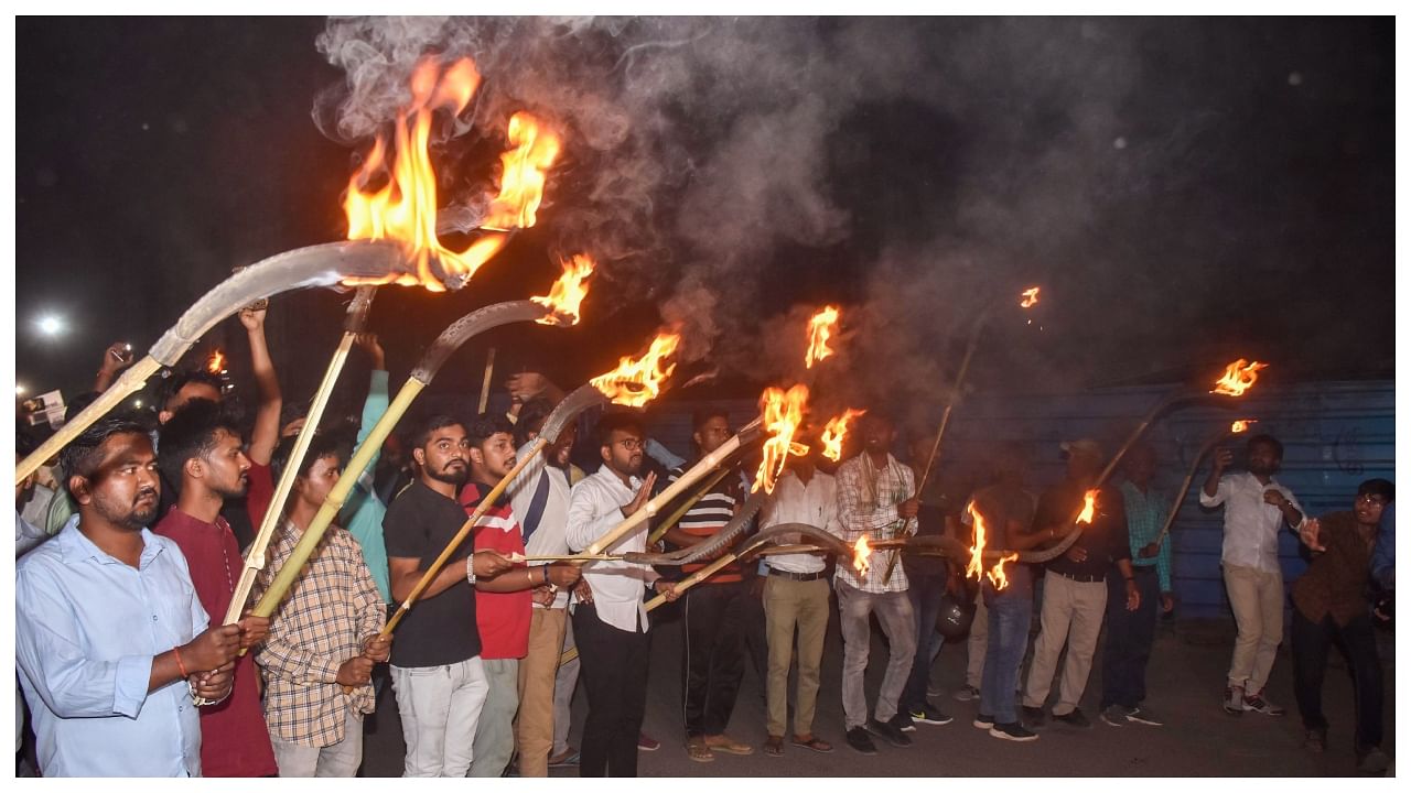 Students take out a torch light procession on the eve of Jharkhand Bandh and stage a protest against Chief Minister Hemant Soren over new employment policy, in Ranchi. Credit: PTI Photo