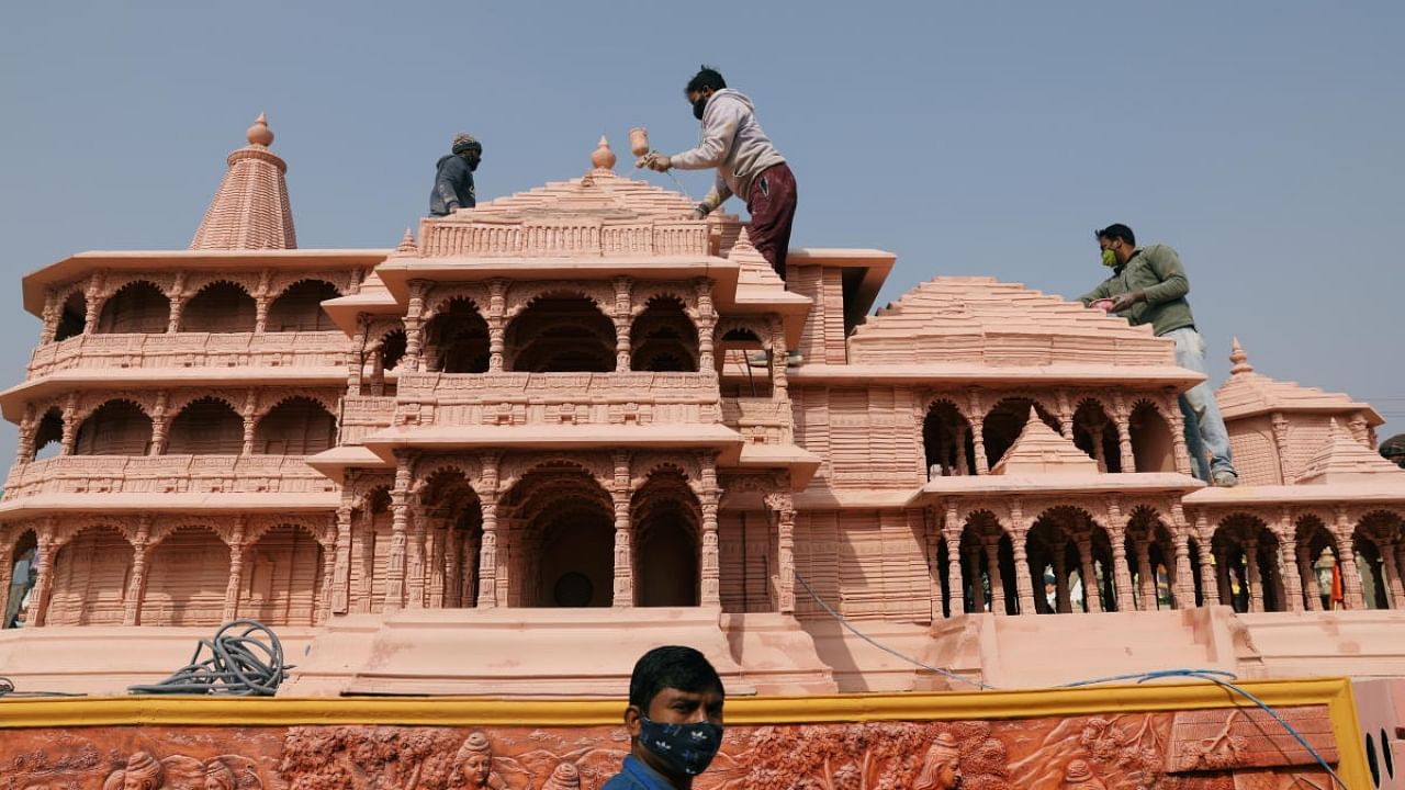 Workers give finishing touches to the model of the proposed Ram temple that Hindu groups want to build at a religious site in Ayodhya, on a tableau during a media preview of tableaux participating in the Republic Day parade in New Delhi, India January 22, 2021. Credit: Reuters File Photo