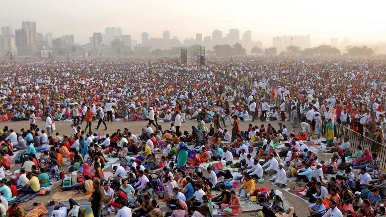 In this photograph taken on April 16, 2023, people gather to attend an award ceremony on the outskirts of Mumbai. - Heatstroke killed 11 people in India after an estimated million spectators waited for hours in the sun at a government-sponsored awards ceremony, officials said as early summer temperatures soared. Credit: AFP Photo