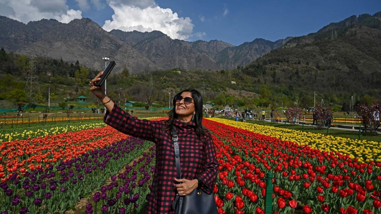 A tourist takes a selfie using a mobile phone at Tulip Garden, claimed to be Asia's largest, in Srinagar on April 5, 2023. Credit: AFP Photo